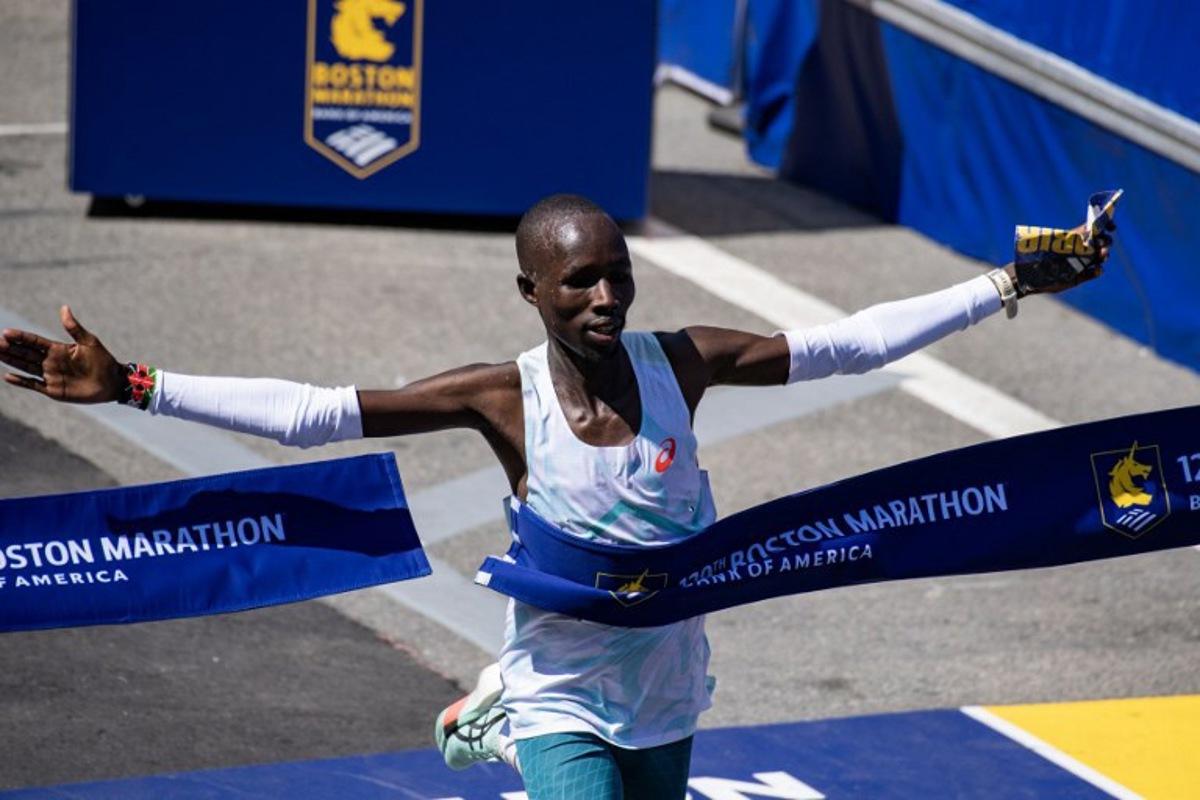 Kenyan distance runner John Korir crosses the finish line as he wins the men's race during the 129th Boston Marathon on April 21, 2025, in Boston, Massachusetts.  The marathon includes around 30,000 athletes from 129 countries running the 26.2 miles from Hopkinton to Boston, Massachusetts.  The event is the world's oldest annually run marathon.  Joseph Prezioso / AFP