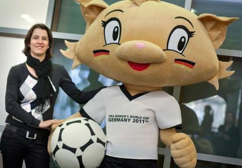 Switzerland's Tatjana Haenni, head of FIFA Women?s Competitions department, poses for photographers with the FIFA Women's World Cup 2011 event's mascott Karla Kick in the central German city of Frankfurt am Main on March 4, 2011.  AFP PHOTO / FRANK RUMPENHORST  GERMANY OUT GERMANY OUT

