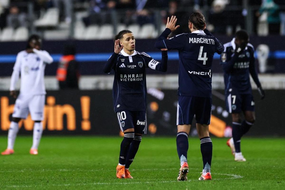 Paris FC's French midfielder #10 Ilan Kebbal (L) celebrates after shooting a penalty and kick and scoring his team first goal with Paris FC's French midfielder #04 Vincent Marchetti (R) during the French L1 football match between Paris FC and AJ Auxerre at the Stade Jean-Bouin stadium, in Paris, on November 29, 2025.  FRANCK FIFE / AFP