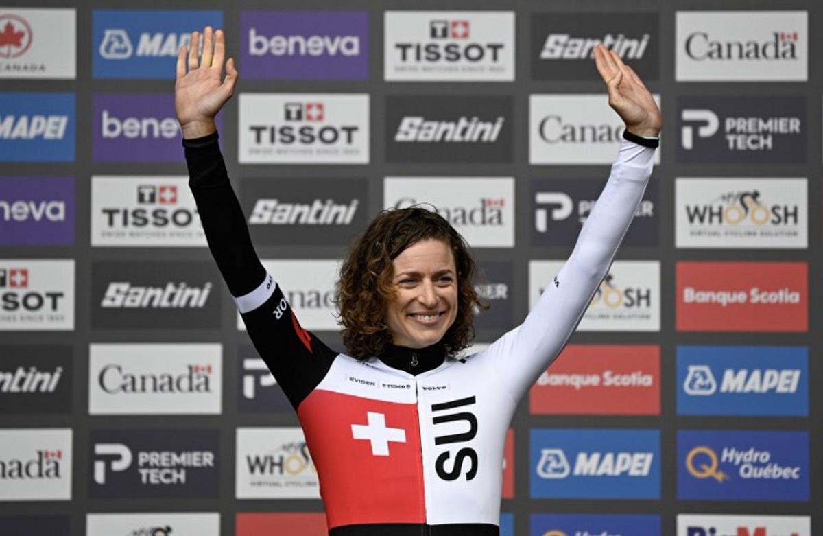 Switzerland's Marlen Reusser celebrates on the podium after finishing in first place in the Women Elite Individual Time Trial during the 2026 Union Cycliste Internationale (UCI) Road World Championships in Montreal, Quebec, on September 20, 2026.  Andrej Ivanov / AFP