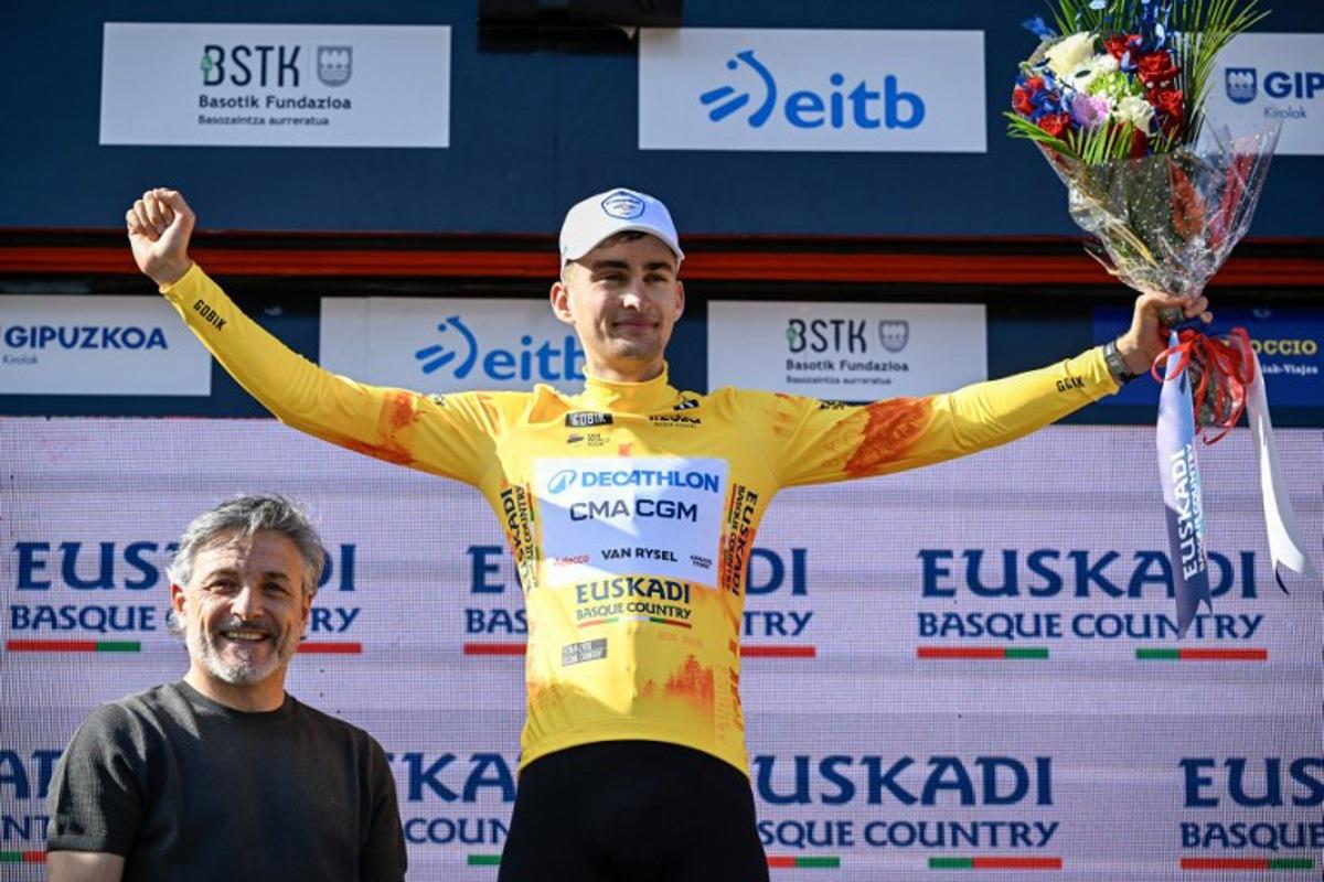 Overall race leader Team Decathlon CMA CGM's French rider Paul Seixas celebrates on the podium following the fourth stage of the Basque Country's Itzulia cycling tour, a 167.2 km race starting and finishing in Galdakao, on April 9, 2026.   ANDER GILLENEA / AFP