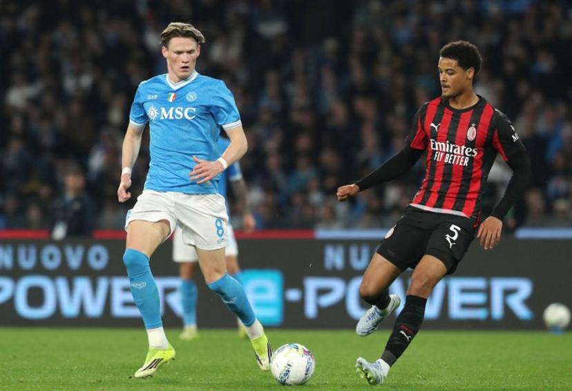 Napoli's Scottish midfielder #08 Scott McTominay (L) and AC Milan's Belgian defender #05 Koni De Winter (R) fight for the ball during the Italian Serie A football match between SSC Napoli and AC Milan at the Diego Armando Maradona Stadium in Naples on April 6, 2026.  CARLO HERMANN / AFP