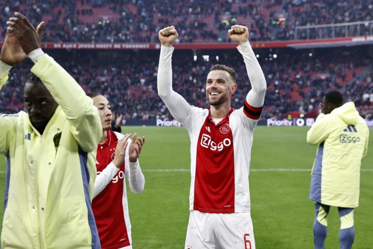 Ajax' Dutch midfielder Kian Fitz-Jim and Ajax's English midfielder #6 Jordan Henderson celebrate the victory of their team at the end of the Dutch Eredivisie football match between AFC Ajax and Feyenoord at the Johan Cruijff ArenA in Amsterdam, on February 2, 2025. Ajax won 2-12 over Feyenoord. MAURICE VAN STEEN / ANP / AFP