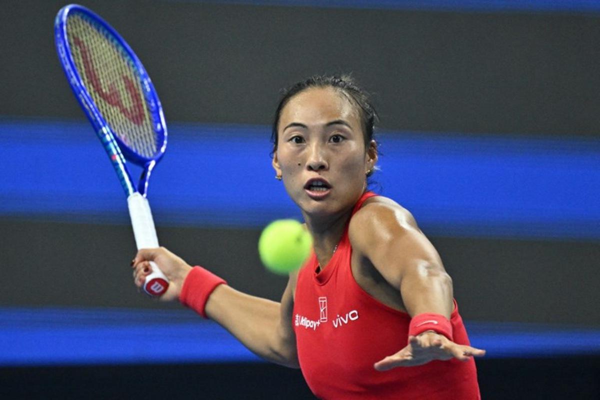 China's Zheng Qinwen hits a return to Russia's Mirra Andreeva during their women's singles final at the China Open tennis tournament in Beijing on October 11, 2026.  Pedro Pardo / AFP