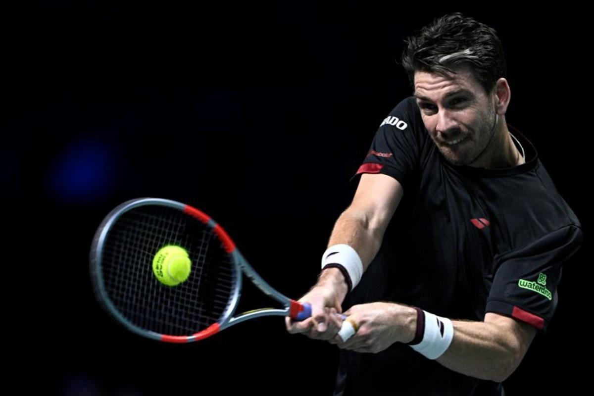 Britain's Cameron Norrie plays a backhand return to Monaco's Valentin Vacherot during their men's singles match on day four of the Paris ATP Masters 1000 tennis tournament at the Paris La Défense Arena in Nanterre, on the outskirts of Paris, on October 30, 2025.  JULIEN DE ROSA / AFP