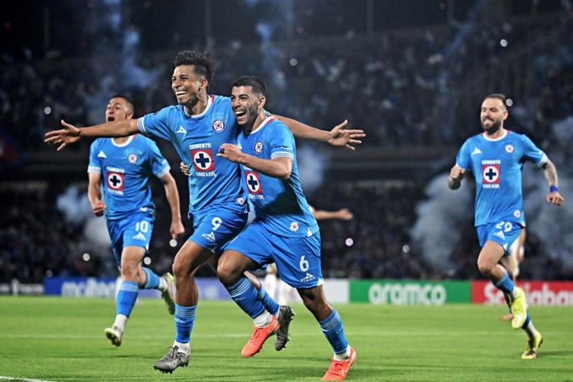 Cruz Azul's forward #09 Angel Sepulveda (L) celebrates with teammate midfielder #06 Erik Lira after scoring a penalty kick and his team's first goal during the CONCACAF Champions Cup all-Mexican semi-final second leg match between Cruz Azul and Tigres at the Olimpico Universitario stadium in Mexico City on May 1, 2025.  Carl de Souza / AFP
