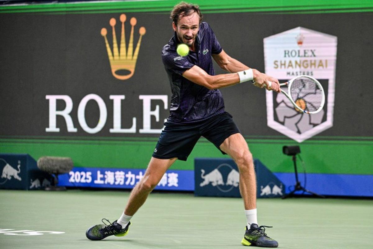 Russia's Daniil Medvedev hits a return to France's Arthur Rinderknech during their men's singles semi-final match at the Shanghai Masters tennis tournament in Shanghai on October 11, 2025.  Hector RETAMAL / AFP
