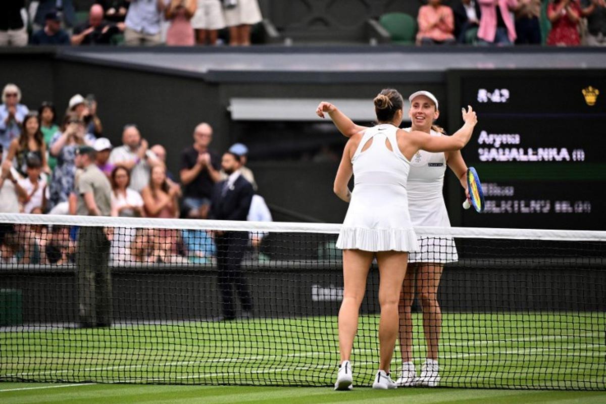 Winner Belarus's Aryna Sabalenka (front) hugs Belgium's Elise Mertens at the end of their women's singles fourth round tennis match on the seventh day of the 2025 Wimbledon Championships at The All England Lawn Tennis and Croquet Club in Wimbledon, southwest London, on July 6, 2025.  Kirill KUDRYAVTSEV / AFP