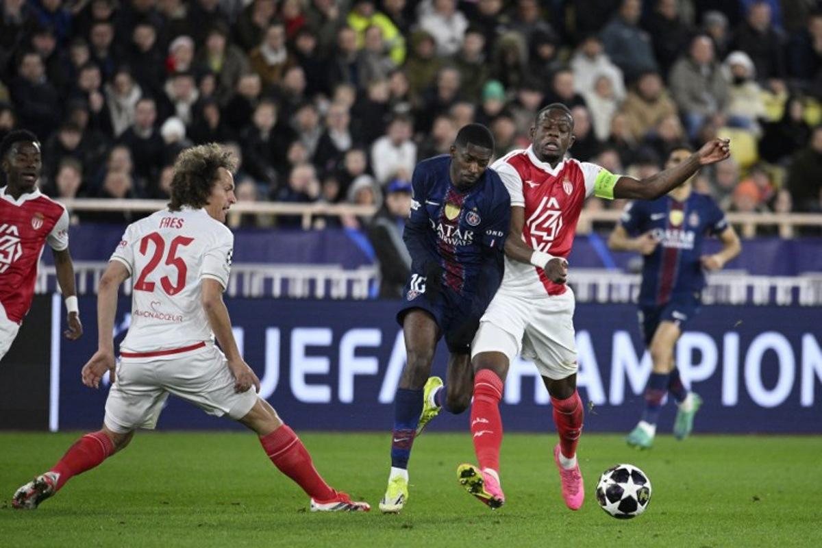 Paris Saint-Germain's French forward #10 Ousmane Dembele (C) and Monaco's Swiss midfielder #06 Denis Zakaria (R) fight for the ball during the UEFA Champions League knockout round play-off first leg football match between AS Monaco and Paris Saint-Germain at the Stade Louis II in the Principality of Monaco on February 17, 2026.  FREDERIC DIDES / AFP