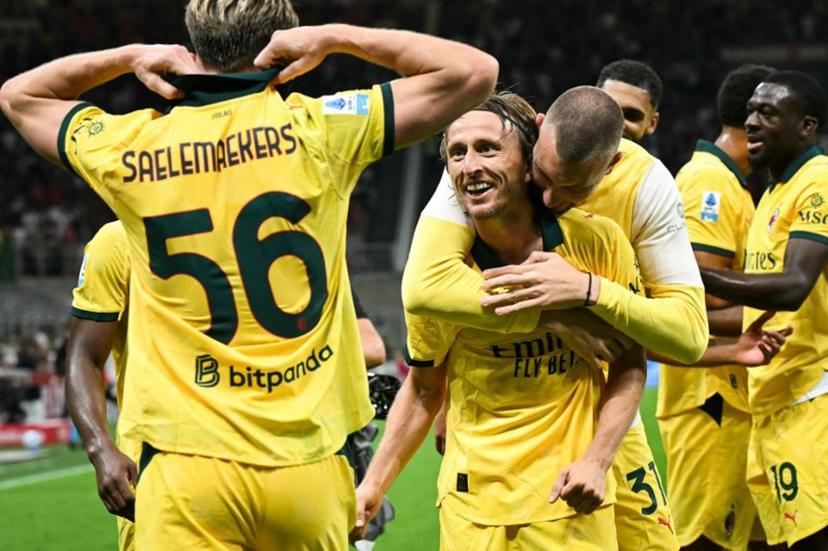 AC Milan's Croatian midfielder #14 Luka Modric (C) celebrates with teammates after scoring his team first goal during the Italian Serie A football match between AC Milan and Bologna at San Siro stadium in Milan, northern Italy, on September 14, 2025.  Stefano RELLANDINI / AFP