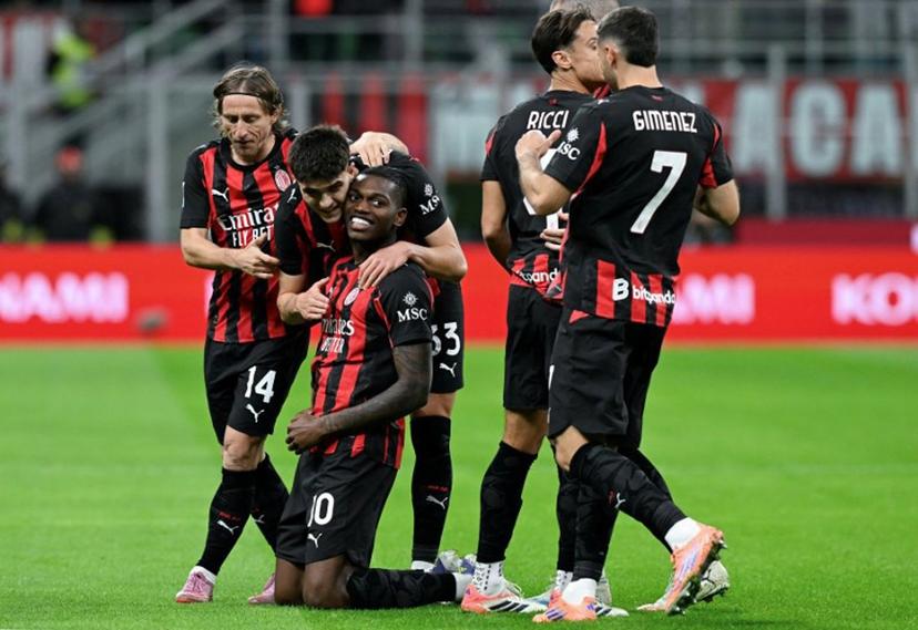 AC Milan's Portuguese forward #10 Rafael Leao (3rd L) celebrates with his teammates after scoring his team's opening goal during the Italian Serie A football match between AC Milan and Pisa SC at San Siro stadium in Milan, northern Italy, on October 24, 2025.  Stefano RELLANDINI / AFP