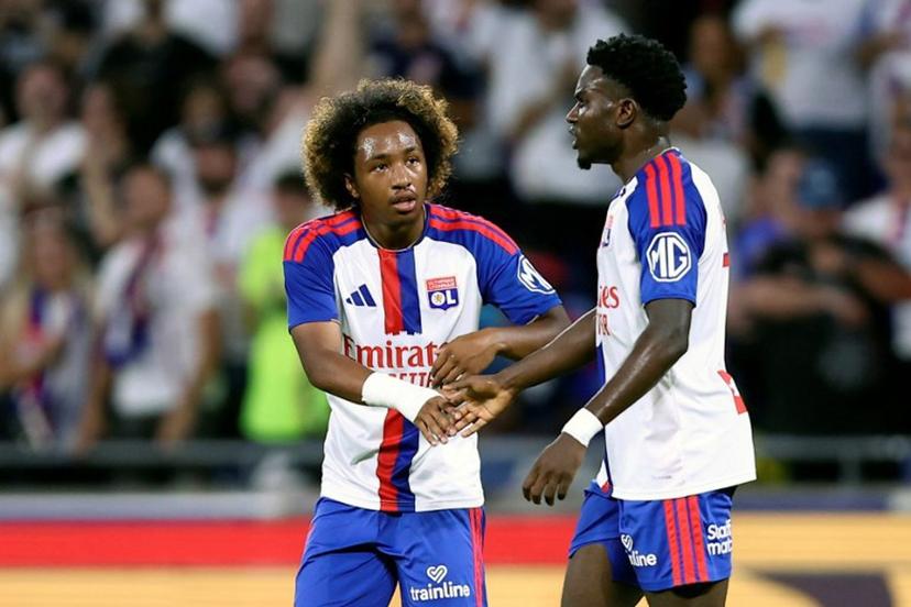 Lyon's Ghanaian forward #7 Ernest Nuamah (R) celebrates with Lyon's Belgian forward #11 Malick Fofana (C) after scoring his team's first goal  during the UEFA Champions League third qualifying round - second leg football match between Olympique Lyonnais (OL) and Sparta Prague at Groupama Stadium in Decines-Charpieu, central-eastern France on August 11, 2026.  Alex MARTIN / AFP