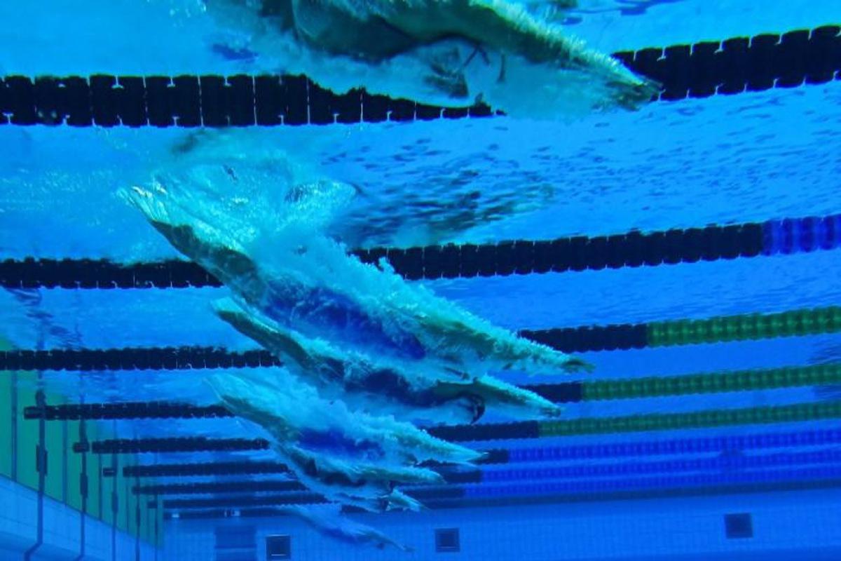 Swimmers are seen through an underwater window as they compete in a heat for the Women¿s 1500m Freestyle Swimming event during the LEN European Aquatics Championships at the Duna Arena in Budapest on May 20, 2021.  Tobias SCHWARZ / AFP