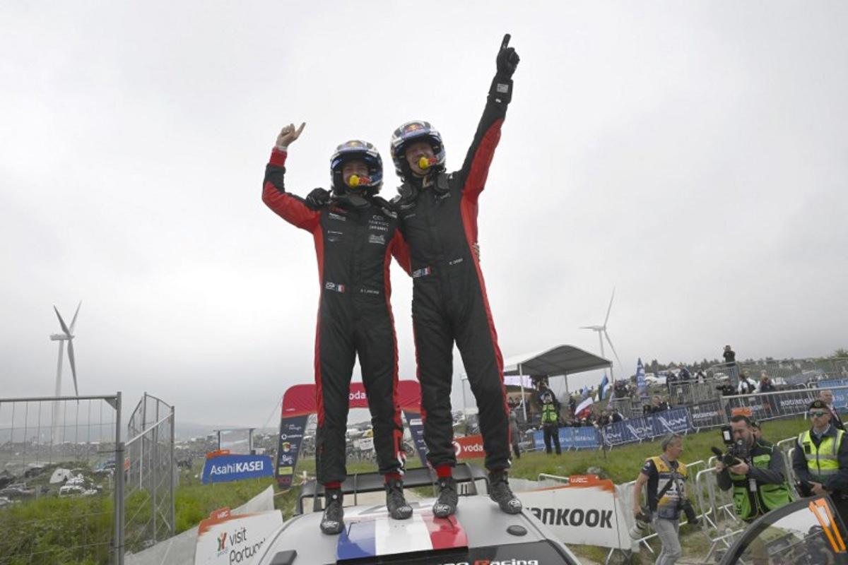 French driver Sebastien Ogier (R) and co-driver Vincent Landais celebrate on top of their Toyota GR Yaris Rally 1 after winning the World Rally Championship (WRC) Rally of Portugal at the end of the SS24 stage in Fafe, on May 18, 2025.  MIGUEL RIOPA / AFP