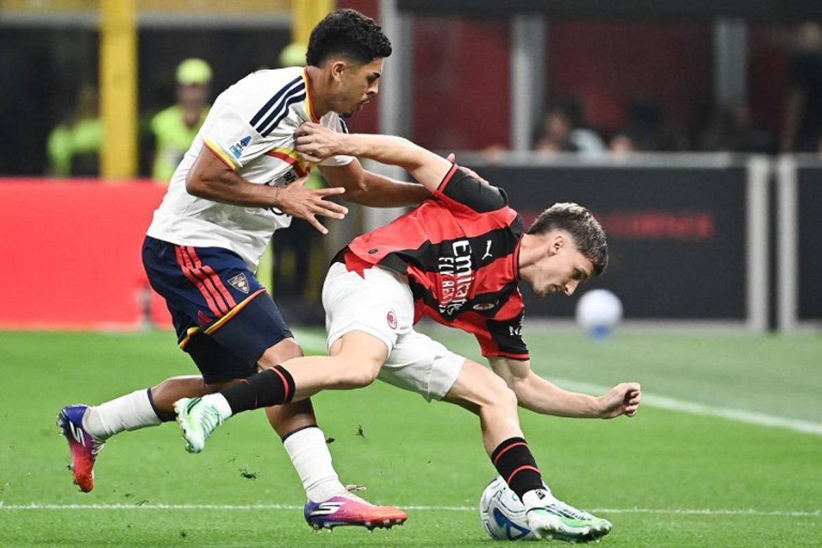 Milan's Belgian midfielder #56 Alexis Saelemaekers (R) fights for the ball with Lecce's Portuguese defender #17 Danilo Veiga during the Italian Serie A football match between AC Milan and Lecce at the San Siro stadium in Milan, on September 20, 2026.  Isabella BONOTTO / AFP