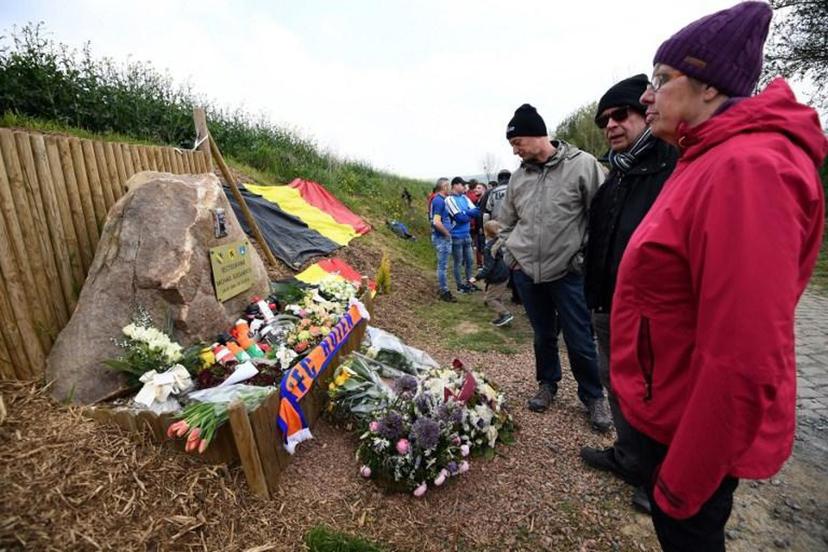 Cyclism supporters stand in front of the memorial as they pay tribute to late Belgian cyclist Michael Goolaerts, the Briastre to Viesly cobbled sector where he fell due to a heart failure, during the 117th edition of the Paris-Roubaix one-day classic cycling race, between Compiegne and Roubaix, near Briastre, northern France on April 14, 2019. Belgian cyclist Michael Goolaerts died in hospital on April 8, 2018 at the age of 23, hours after suffering heart failure during the gruelling Paris-Roubaix one-day classic race in France. Anne-Christine POUJOULAT / AFP