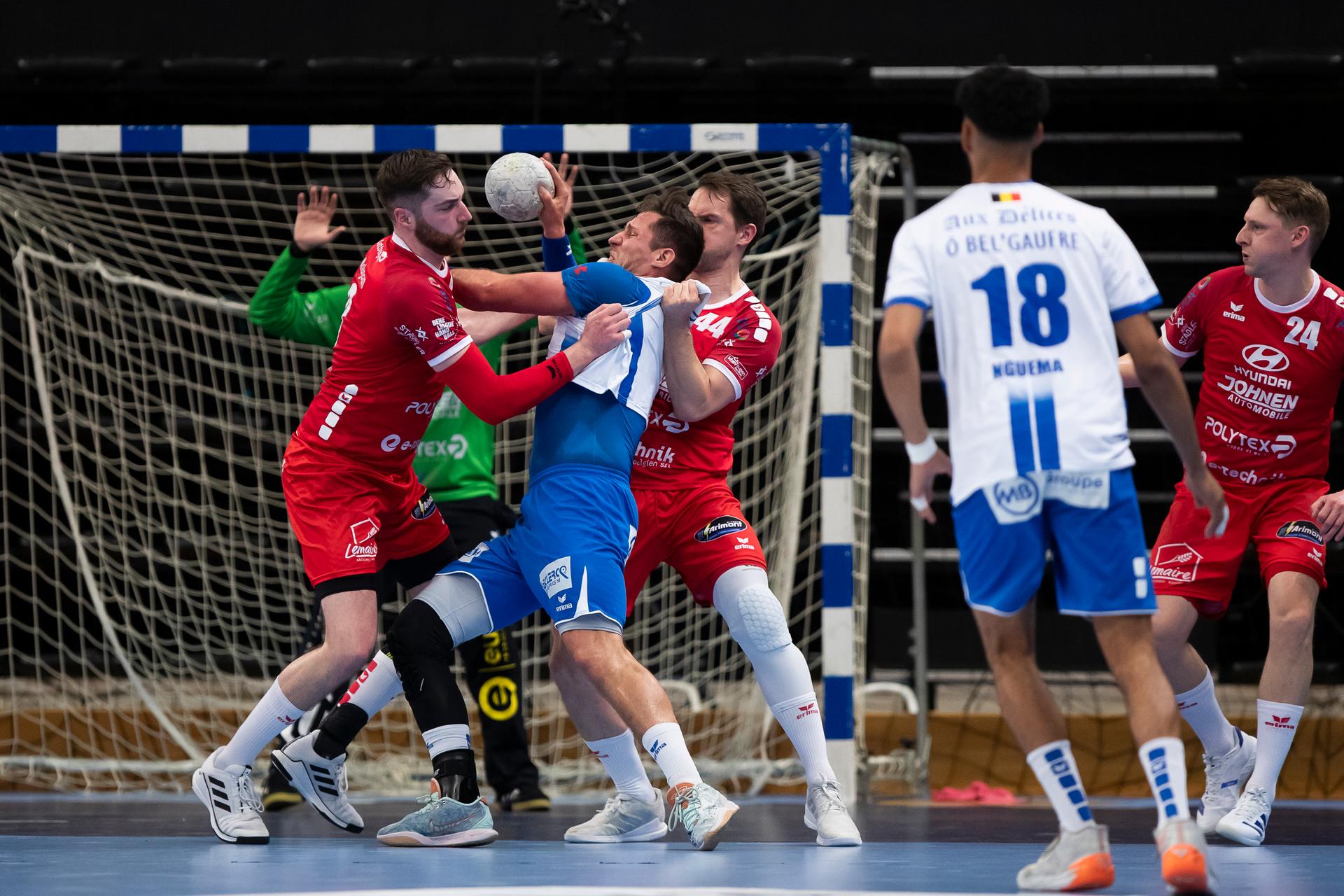 Eupen's Jerome Majean, Vise's Yves Vancosen and Eupen's Bartosz Kedziora fight for the ball during a game between KTSV Eupen and HC Vise BM, Saturday 30 March 2024, in Hasselt, the men's final of the Belgian handball cup. BELGA PHOTO KRISTOF VAN ACCOM