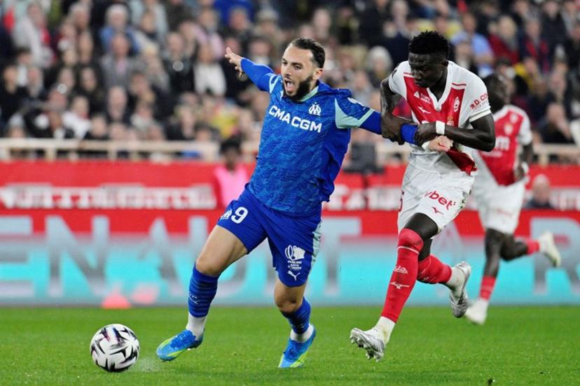 Marseille's Algerian forward #09 Amine Gouiri (L) vies with Monaco's Senegalese midfielder #15 Lamine Camara (R) during the French L1 football match between Monaco (ASM) and Olympique de Marseille (OM) at the Louis II Stadium in Monaco on April 5, 2026.  Frederic DIDES / AFP