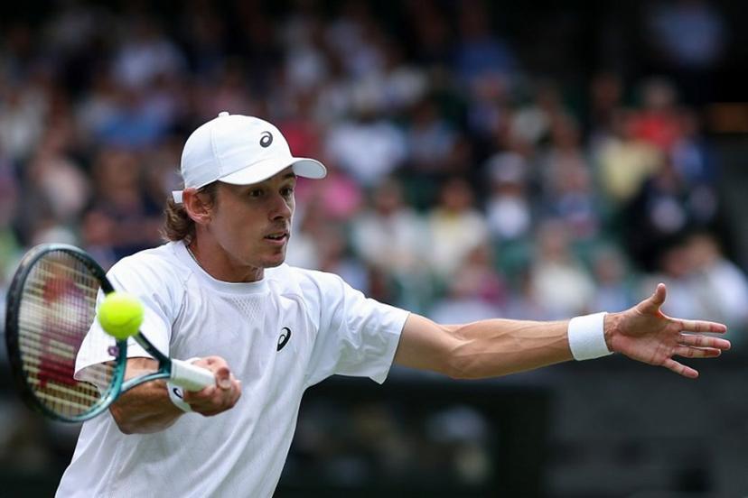 Australia's Alex De Minaur plays a forehand return to Serbia's Novak Djokovic during their men's singles fourth round tennis match on the eighth day of the 2025 Wimbledon Championships at The All England Lawn Tennis and Croquet Club in Wimbledon, southwest London, on July 7, 2025.  Adrian Dennis / AFP