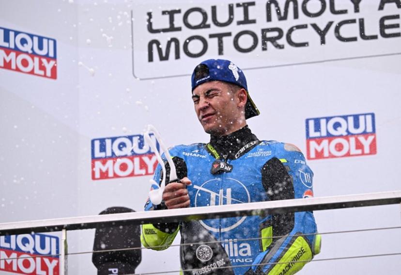 Winner Trackhouse MotoGP Team's Spanish rider Raul Fernandez celebrates with sparkling wine on the podium after the MotoGP Australian Grand Prix on Philip Island on October 19, 2025.  WILLIAM WEST / AFP