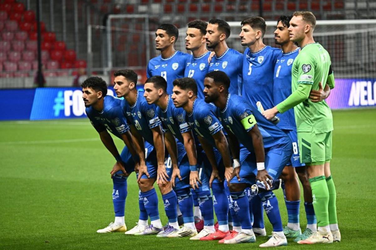 Israeli players (L to R Bottom) Israel's defender #03 Roy Revivo, Israel's midfielder #20 Dan Biton, Israel's midfielder #11 Oscar Gloukh, Israel's forward #10 Manor Solomon and Israel's defender #02 Eli Dasa (over) Israel's forward #13 Anan Khalaili, Israel's defender #12 Stav Lemkin, Israel's midfielder #15 Eliel Peretz, Israel's defender #05 Idan Nachmias, Israel's midfielder #08 Dor Peretz and Israel's goalkeeper #01 Daniel Peretz pose for a team photo prior to the 2026 World Cup qualifiers Europe zone group I football match between Israel and Italy on September 8, 2025 in Debrecen, Hungary.  Attila KISBENEDEK / AFP