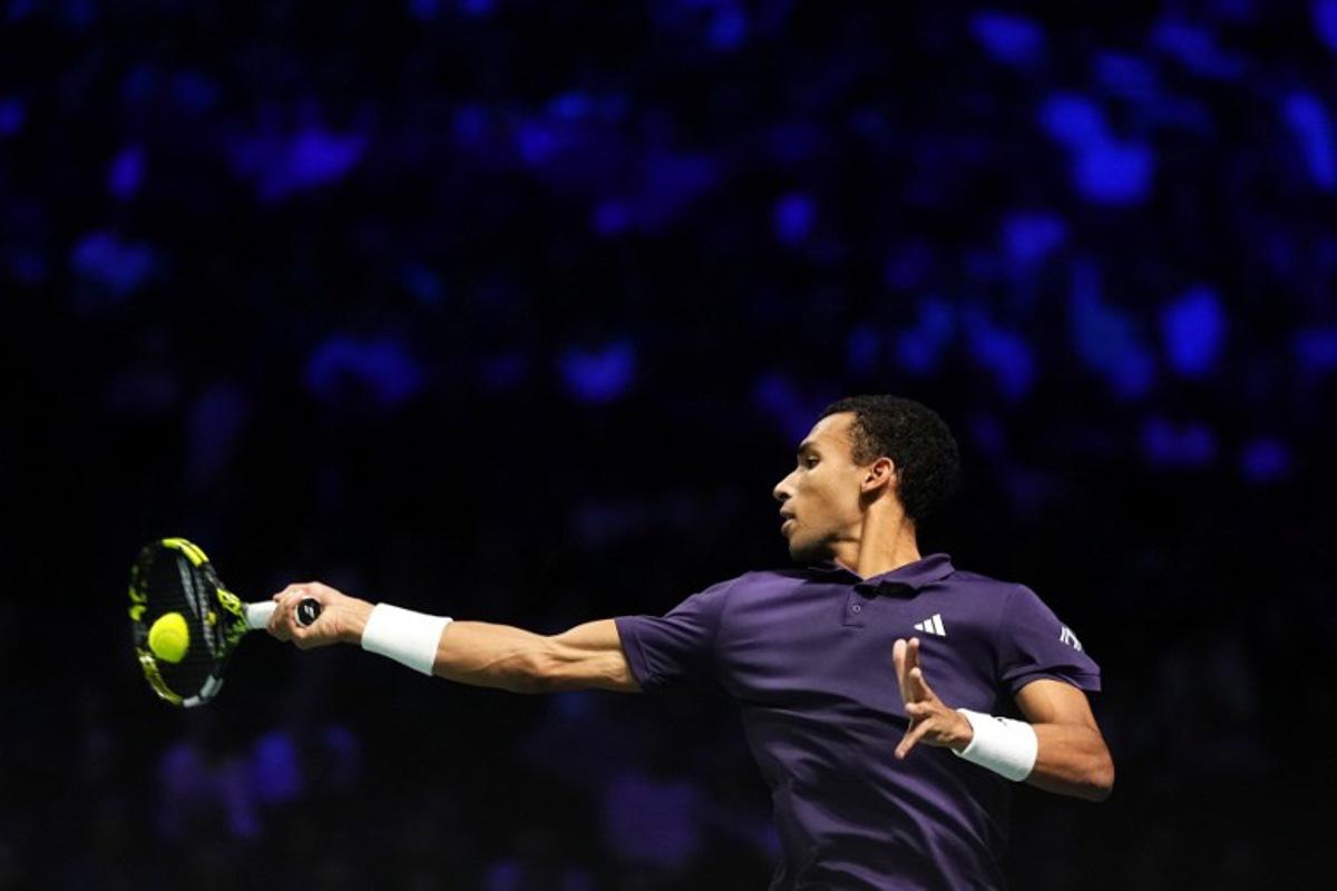 Canada's Felix Auger-Aliassime plays a forehand return to Kazakhstan's Alexander Bublik during their men's singles semi-final match on day six of the Paris ATP Masters 1000 tennis tournament at the Paris La Défense Arena in Nanterre, on the outskirts of Paris, on November 1, 2025.  Dimitar DILKOFF / AFP