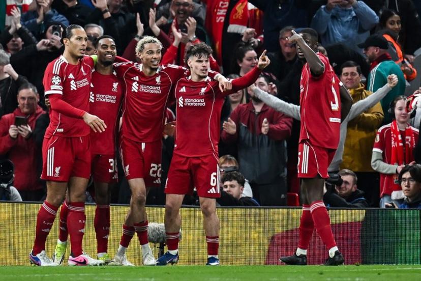 Liverpool's Dutch midfielder #38 Ryan Gravenberch (2L) celebrates with teammates after scoring his team's third goal during the UEFA Champions League, round of 16 second leg football match between Liverpool and Galatasaray at Anfield in Liverpool, north-west England on March 18, 2026.  Paul ELLIS / AFP
