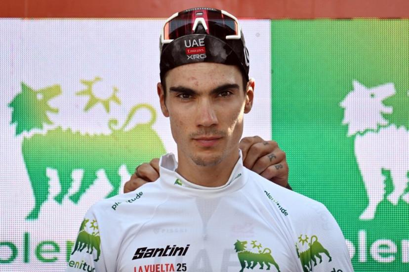 Team UAE's Spanish rider Juan Ayuso celebrates on the podium retaining the best youth white jersey after the fourth stage of the Vuelta a Espana, a 192 km race between Susa and Voiron, in the Alps, on August 26, 2025.    Jeff PACHOUD / AFP