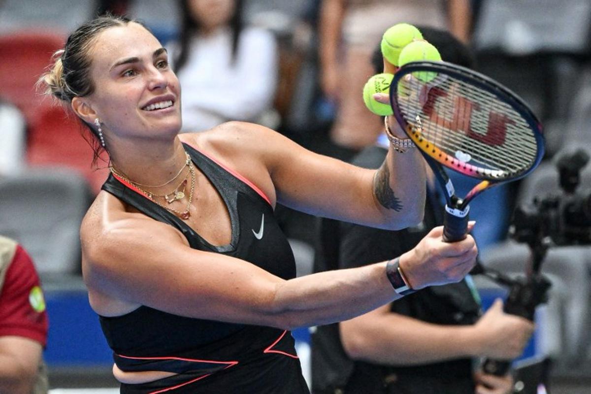 Belarus' Aryna Sabalenka prepares to hit balls to fans after winning against Kazakhstan's Elena Rybakina during their women's singles quarterfinal match at the Wuhan Open tennis tournament in Wuhan, Central China's Hubei province on October 10, 2025.  ADEK BERRY / AFP