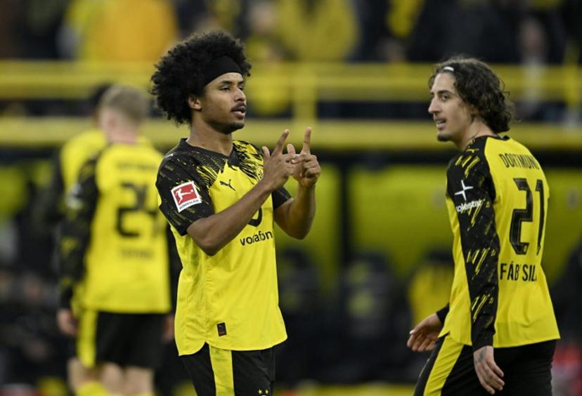 Dortmund's German forward #27 Karim Adeyemi (L) celebrates after scoring the 2-0 goal during the German first division Bundesliga football match between BVB Borussia Dortmund and FC St Pauli in Dortmund, western Germany, on January 17, 2026.  INA FASSBENDER / AFP