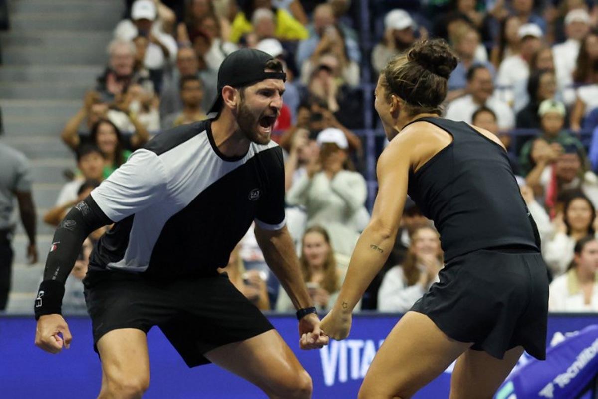 Italy's Andrea Vavassori (L) and Sara Errani celebrate after winning their mixed doubles final tennis match against Norway's Casper Ruud and Poland's Iga Swiatek at the US Open tennis tournament at the USTA Billie Jean King National Tennis Center in New York City, on August 20, 2025.  TIMOTHY A.CLARY / AFP