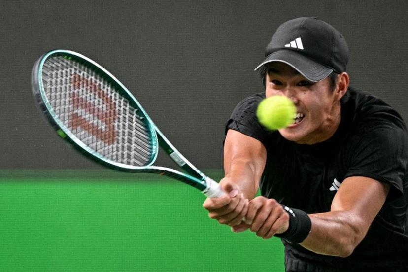 United States's Learner Tien hits a return to Russia's Daniil Medvedev during their men's singles match at the Shanghai Masters tennis tournament in Shanghai on October 8, 2025.  HECTOR RETAMAL / AFP
