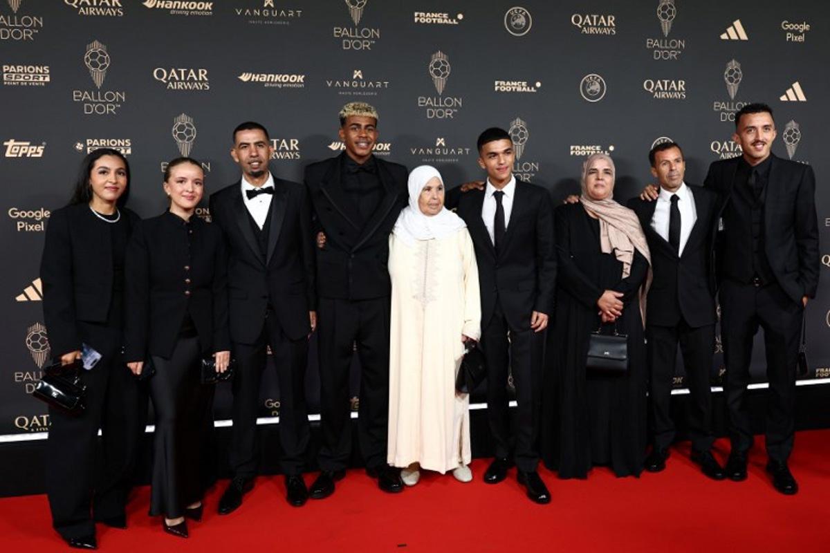 Barcelona's Spanish forward Lamine Yamal (4thL) poses with his family upon arrival before the 2025 Ballon d'Or France Football award ceremony at the Theatre du Chatelet in Paris on September 22, 2025.  FRANCK FIFE / AFP