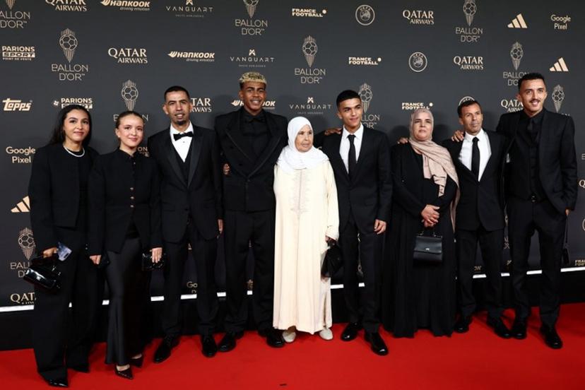 Barcelona's Spanish forward Lamine Yamal (4thL) poses with his family upon arrival before the 2025 Ballon d'Or France Football award ceremony at the Theatre du Chatelet in Paris on September 22, 2025.  FRANCK FIFE / AFP
