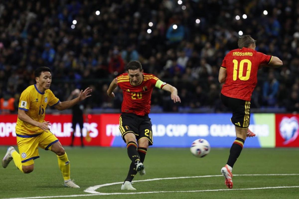 Kazakhstan's defender Erkin Tapalov, Belgium's midfielder #20 Hans Vanaken and Belgium's midfielder #10 Leandro Trossard vie for the ball during the FIFA World Cup 2026 qualifiers Europe zone group J football match between Kazakhstan and Belgium at the Astana Arena in Astana on November 15, 2025.  STANISLAV FILIPPOV / AFP