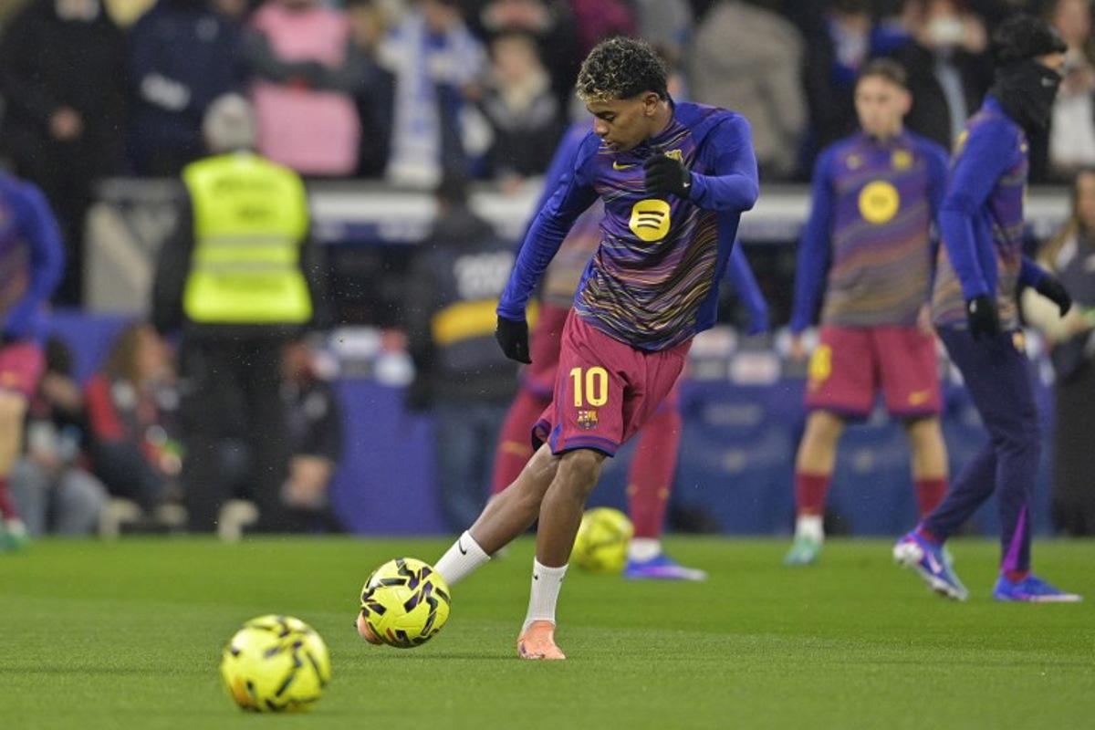 Barcelona's Spanish forward #10 Lamine Yamal warms up before the Spanish League football match between RCD Espanyol and FC Barcelona at RCDE Stadium in Cornella de Llobregat on January 3, 2026.  MANAURE QUINTERO / AFP