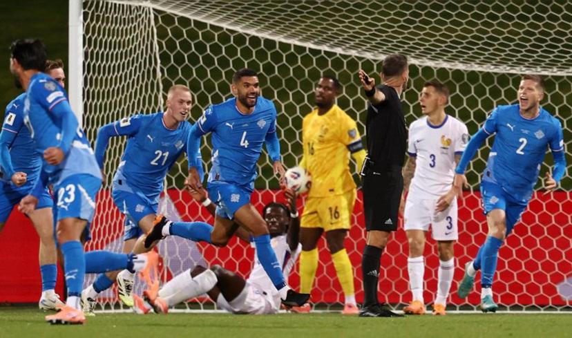 Iceland's defender #04 Victor Palsson (C) celebrates scoring his team's first goal with teammates during the 2026 World Cup qualifying round Group D football match between Iceland and France at the Laugardalsvollur Stadium in Reykjavik on October 13, 2025.    FRANCK FIFE / AFP