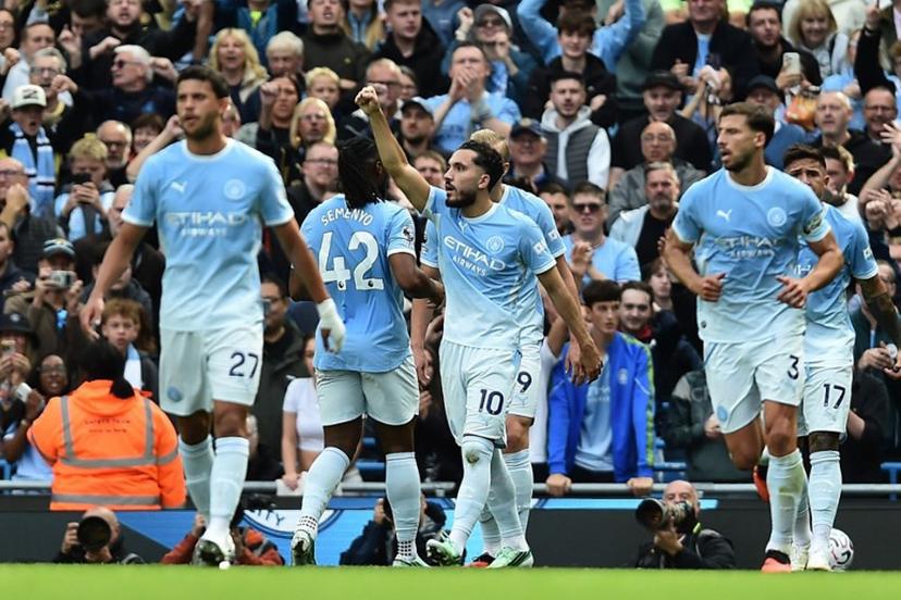 Manchester City's French midfielder #10 Rayan Cherki (C) celebrates with teammates after scoring their second goal during the English Premier League football match between Manchester City and Sunderland at the Etihad Stadium in Manchester, north west England, on September 20, 2026.  PETER POWELL / AFP