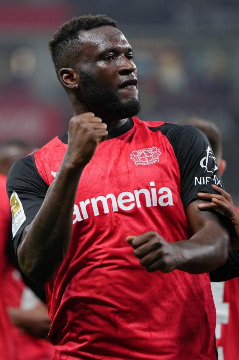 Bayer Leverkusen's Nigerian forward #22 Victor Boniface celebrates scoring the 2-1 goal with his teammates during the German first division Bundesliga football match between Bayer 04 Leverkusen and VfL Bochum in Leverkusen, western Germany on March 28, 2025.  Pau BARRENA / AFP