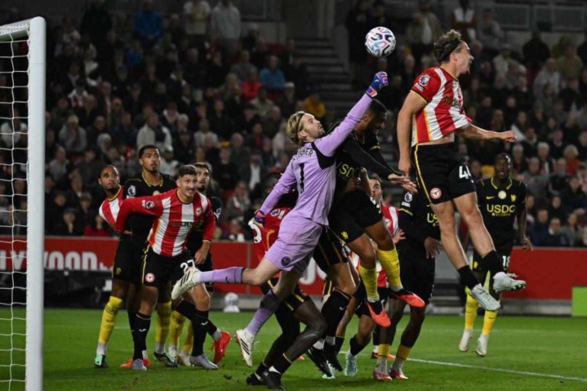 Brentford's Irish goalkeeper #01 Caoimhin Kelleher punches the ball clear during the English Premier League football match between Brentford and Chelsea at the Gtech Community Stadium in London on September 18, 2026.  Glyn KIRK / AFP
