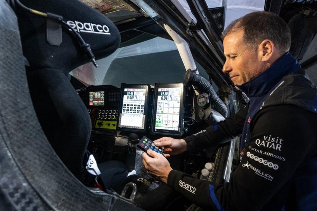 French co-driver Mathieu Baumel checks the navigation instruments in Nasser Racing's Qatari driver Nasser Al-Attiyah's car after Stage 5 of the Dakar Rally 2024, between Al Hofuf and Shubaytah, Saudi Arabia, on January 10, 2024.  PATRICK HERTZOG / AFP