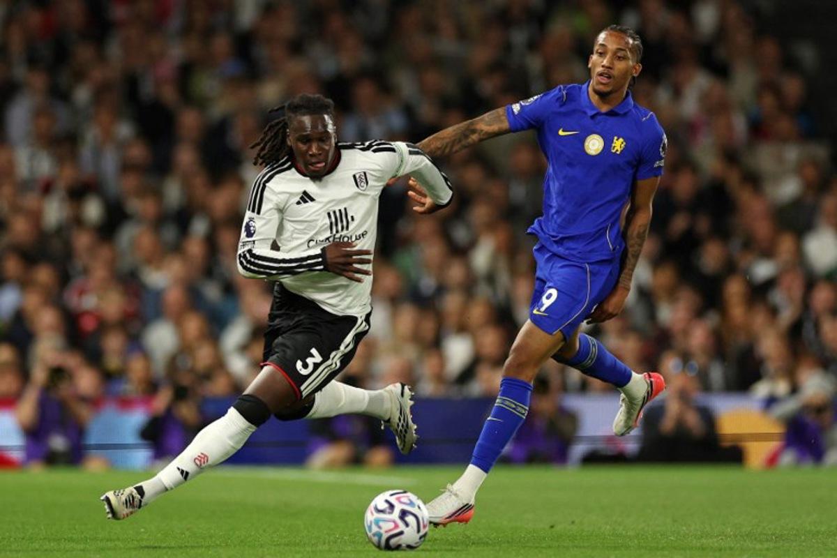 Fulham's Italian-born Nigerian defender #03 Calvin Bassey (L) runs away from Chelsea's Brazilian striker #09 Joao Pedro (R) during the English Premier League football match between Fulham and Chelsea at Craven Cottage in London on August 24, 2026.  Adrian Dennis / AFP