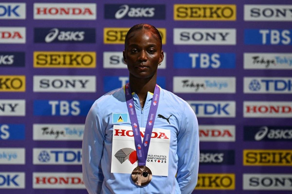Bronze medallist Saint Lucia's Julien Alfred poses with her medal on the podium for the women's 100m final during the World Athletics Championships in Tokyo on September 15, 2025.  Philip FONG / AFP