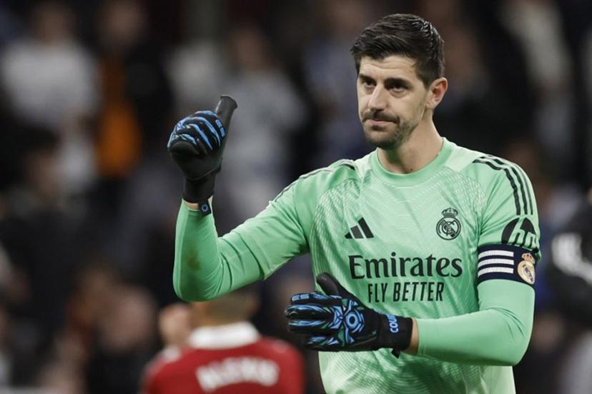 Real Madrid's Belgian goalkeeper #01 Thibaut Courtois celebrates at the end of the Spanish league football match between Real Madrid CF and Sevilla FC at Santiago Bernabeu Stadium in Madrid on December 20, 2025.  Oscar DEL POZO / AFP