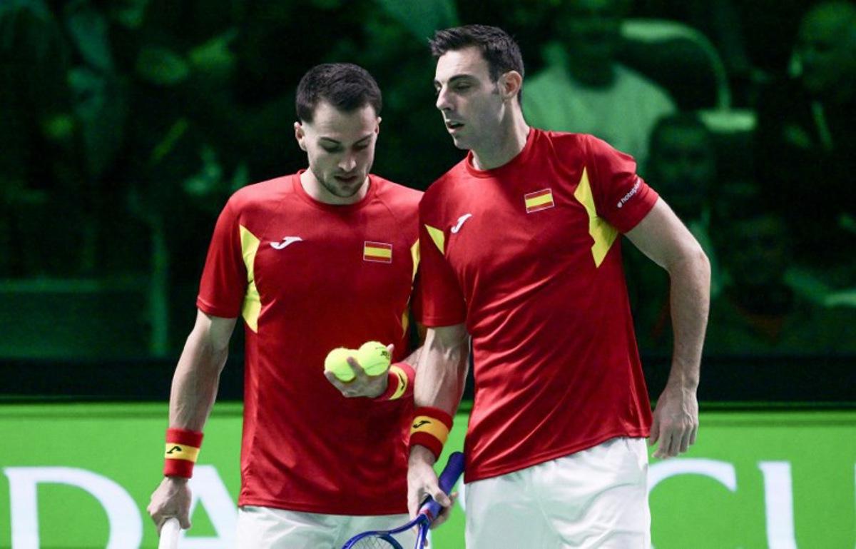 Spain's Pedro Martinez Portero (R) stands next to Spain's Marcel Granollers-Pujol preparing to serve the ball during their 2025 Davis Cup semi-final doubles tennis match against Germany at the Super Tennis Arena in Bologna, northen Italy, on November 22, 2025.  Tiziana FABI / AFP