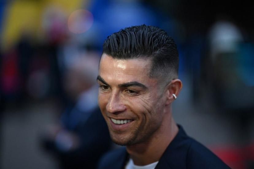 Portugal's forward #07 Cristiano Ronaldo speaks to journalists as he and his teammates arrive at their hotel at their base camp in Harsewinkel, on June 13, 2024, ahead of the UEFA Euro 2024 football championship.  PATRICIA DE MELO MOREIRA / AFP