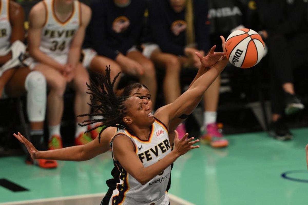 (L-R) New York Liberty #8 Nyara Sabally attempts to block a shot by Indiana Fever #0 Kelsey Mitchell during a WNBA game between the Fever and Liberty, at the Barclays Center in Brooklyn on May 18, 2024, in New York City.  ANGELA WEISS / AFP