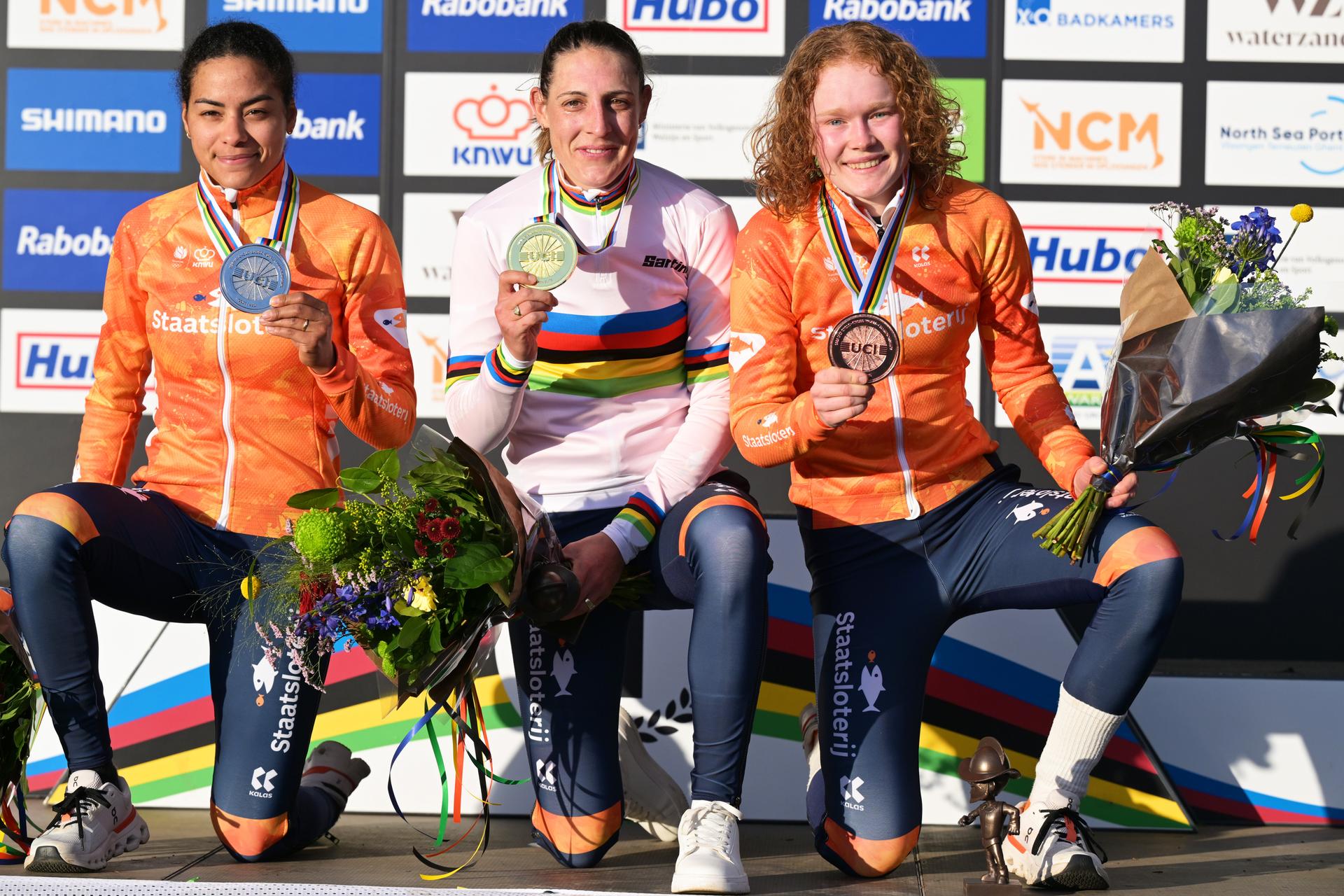 L-R, silver medalist Dutch Ceylin del Carmen Alvarado, winner world champion  Dutch Lucinda Brand and bronze medalist Dutch Puck Pieterse celebrate on the podium of the elite women race at the UCI Cyclocross World Championships, on Saturday 31 January 2026, in Hulst, The Netherlands. BELGA PHOTO DAVID PINTENS