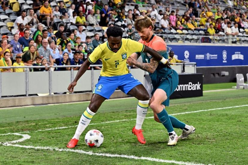 Brazil's Vinicius Junior (L) and Australia's Connor Metcalfe fight for the ball during the International friendly football match between Australia and Brazil at Queensland Country Bank Stadium in Townsville on September 25, 2026.  SAEED KHAN / AFP