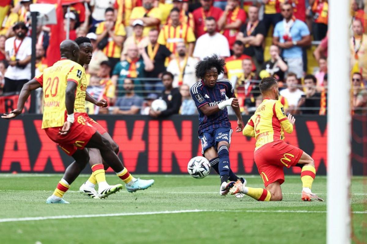 Lyon's Belgian forward #11 Malick Fofana (C) kicks the ball as he tries to score during the French L1 football match between RC Lens and Olympique Lyonnais (OL) at Stade Bollaert-Delelis in Lens, northern France on August 16, 2025.  Sameer Al-DOUMY / AFP